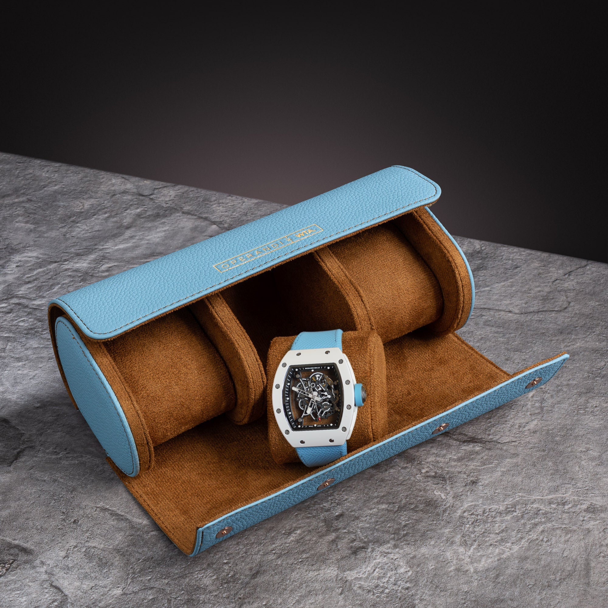 Operandi x WTA Pista Blue triple watch roll open with a white racing watch, baby blue calfskin over cognac suede